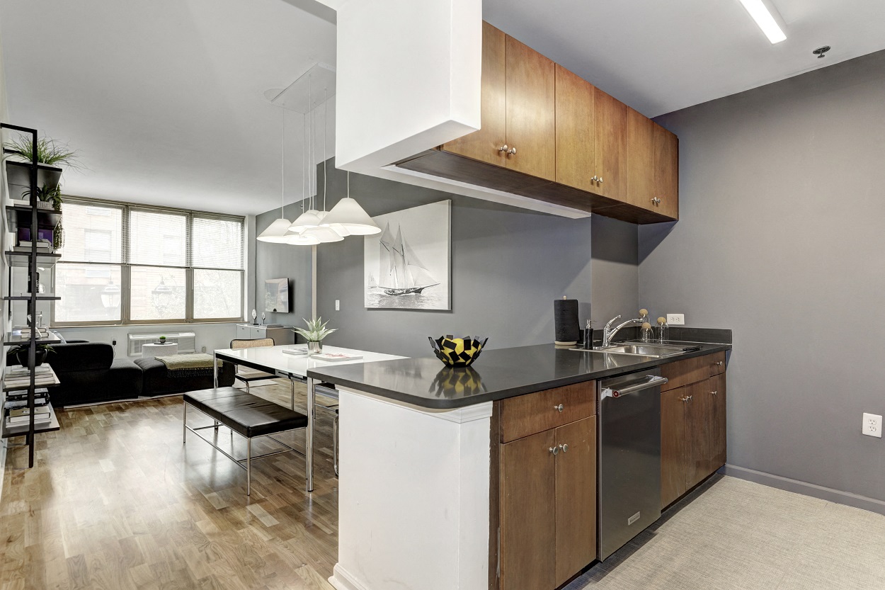 a kitchen with an island and a living room with a table